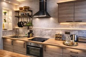a kitchen with a sink and a stove at Loft Prenium PETITE FRANCE-idéal mission Pro-long séjour in Strasbourg