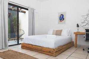 a bedroom with a bed and a window at Outsite Los Cabos - Entire 4-Bedroom Home in San José del Cabo