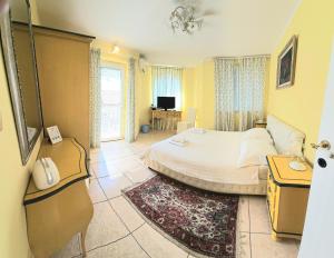 a bedroom with a bed and a desk and a television at Casa Oasa Boutique rooms Pool near Koper in Koper