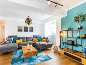 a living room with a couch and a table at Prora - Apartment mit Sauna - Baltic Sunset in Binz