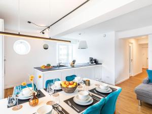 a kitchen and dining room with a table and chairs at Prora - Apartment mit Sauna - Baltic Sunset in Binz