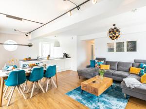 a living room with a couch and a table at Prora - Apartment mit Sauna - Baltic Sunset in Binz +18 photos