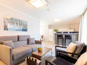a living room with a couch and a fireplace at Prora Block 1 - Ferienwohnung mit Pool, Sauna und Fitness - Sonnenschein in Binz