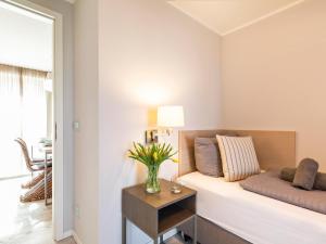 a living room with a couch and a table at Prora Block 1 - Ferienwohnung mit Pool, Sauna und Fitness - Sonnenschein in Binz +14 photos
