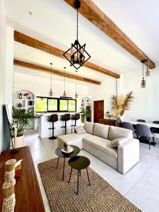 a living room with a couch and a table at Casa De Made - Villas in Jembrana