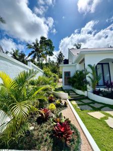 a garden in front of a house with plants at Casa De Made - Villas in Jembrana