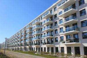 an apartment building with balconies on a street at Prora Block 1 - Sauna, Pool und Fitness - Meerzeit in Binz
