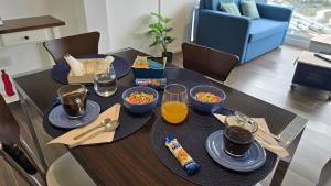 a table with plates and bowls of food on it at Turek Residences in Ushuaia