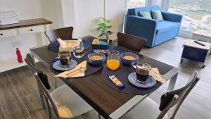 a dining room table with food and drinks on it at Turek Residences in Ushuaia