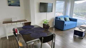 a living room with a table and a blue couch at Turek Residences in Ushuaia +107 photos