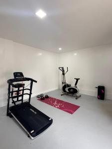 a room with a gym with a treadmill and a exercise bike at Haraya Beach House in Roxas City +18 photos