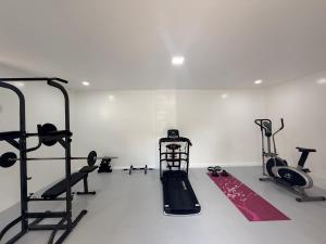 a gym with tread machines and a treadmill at Haraya Beach House in Roxas City