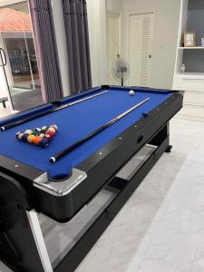 a pool table in a living room with at The Natphop pool villa Meeting Pool Villa in Cha Am