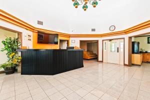 an empty lobby with a bar in the middle at Moonlight Inn Hotel O Hattiesburg, MS in Hattiesburg