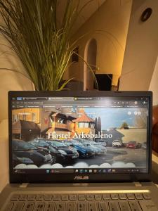 a laptop computer sitting on top of a table at Hostel Arkobaleno sieci Mazowia Hostels Group in Marki