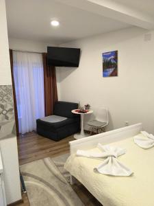 a living room with two beds and a couch at TOKIs apartmani in Mrkonjić Grad