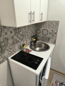 a small kitchen with a sink and a stove at TOKIs apartmani in Mrkonjić Grad +96 photos