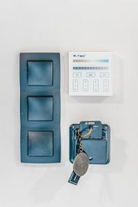 a blue wallet with a key next to a box at Nima Suites Corfu in Marathias