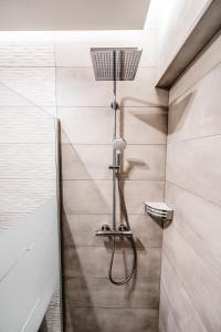 a shower with a shower head in a bathroom at Nima Suites Corfu in Marathias +18 photos