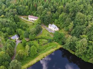 an aerial view of a house and a lake at Studio aux Sources de la Chabanne in Saint-Hilaire-les-Courbes