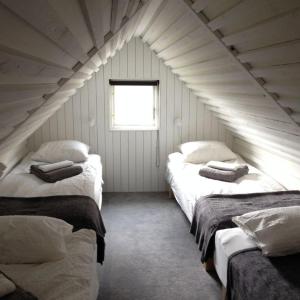 a room with three beds in a attic at Stugan på Skårby in Ystad