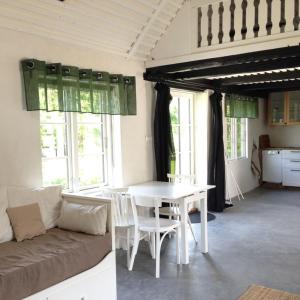 a living room with a white table and a couch at Stugan på Skårby in Ystad