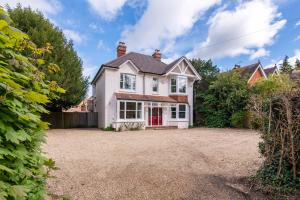 a house with a large yard in front of it at The Coach House, Gatwick in Horley