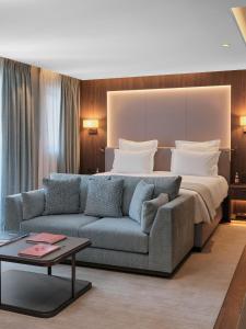 a hotel room with a bed and a couch at Maya Hôtel Courchevel 1850 in Courchevel