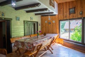 a dining room with a table and a window at Pensiunea Padina in Bran