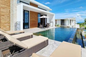 a swimming pool in the backyard of a villa at Passot Hills - Villas Premium in Nosy Be