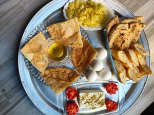 a plate of food with eggs and bread and dip at Sunrise in Abu Simbel