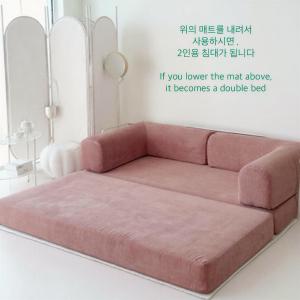 a pink couch in a living room at Jeonpo Cafe Street Near Seomyeon Entire House 2 Floors 7 Guests in Busan