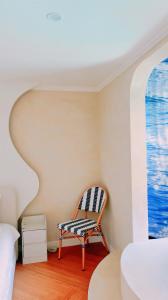 a chair sitting in a room with a window at Jeonpo Cafe Street Near Seomyeon Entire House 2 Floors 7 Guests in Busan