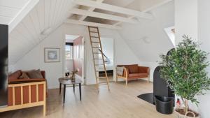a living room with a ladder and a couch at Villavilla 148 - Ebeltoft, Østjylland in Ebeltoft