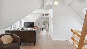 a living room with two couches and a tv at Villavilla 148 - Ebeltoft, Østjylland in Ebeltoft +16 photos