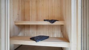 a wooden shelf in a sauna with two pillows on it at Villavilla 640 - Saksild, Østjylland in Odder
