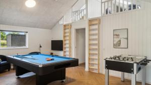 a living room with a pool table and a book shelf at Villavilla 640 - Saksild, Østjylland in Odder