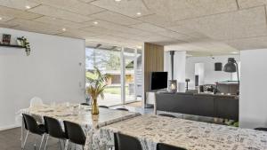 a dining room with a table and chairs at Villavilla 637 - Vorupør, Nordjylland in Stenbjerg