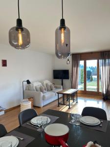 a living room with a black table and chairs at Apartment with a garden, close to golf in Lens
