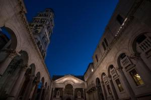 a view of a building with a clock tower at night at Murum Heritage Hotel in Split