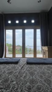 a large room with large windows and a large rug at Villa Panorama Amed in Ambat