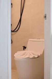 a bathroom with a white toilet in a room at Rungarun Residence in Ratchaburi +8 photos
