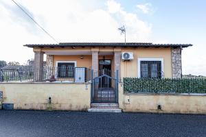 a small house with a gate in front of it at Maison de Marino - B&Brother's rome in Marino