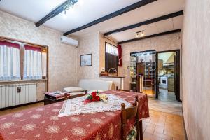 a dining room with a table and a kitchen at Maison de Marino - B&Brother's rome in Marino