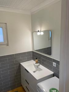 a bathroom with a sink and a mirror at Relaxing Riverside Escape & Stunning Sunset Views in Santa Comba Dão +13 photos