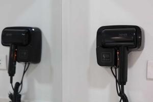 two phones are hanging on a wall at Rungarun Residence in Ratchaburi