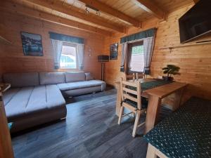 a living room with a couch and a table at Chaty Hrubý in Dolní Moravice