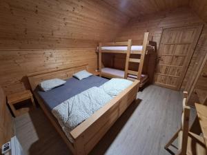 an overhead view of a cabin with a bed and a ladder at Chaty Hrubý in Dolní Moravice