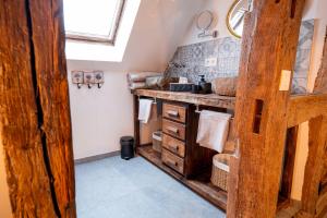 a bathroom with a wooden counter and a sink at les jardins de la ferme in Soumagne