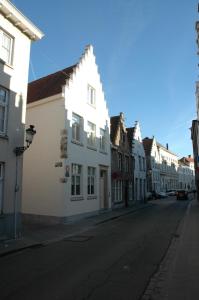 an empty street in a city with buildings at La Luna Guesthouse in Bruges